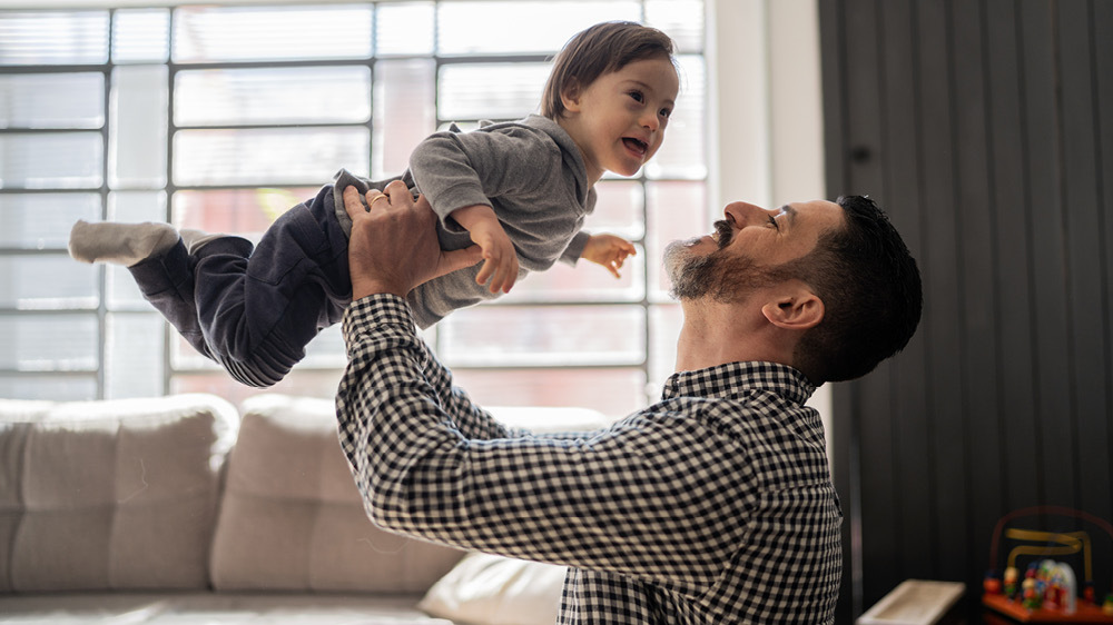 father holding child and smiling